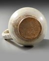 A FINE SLIP-PAINTED POTTERY MUG, PERSIA, 9TH-10TH CENTURY