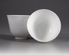 A  PAIR OF SMALL CHINESE WHITE-GLAZED DRAGONS CUPS, 20TH CENTURY