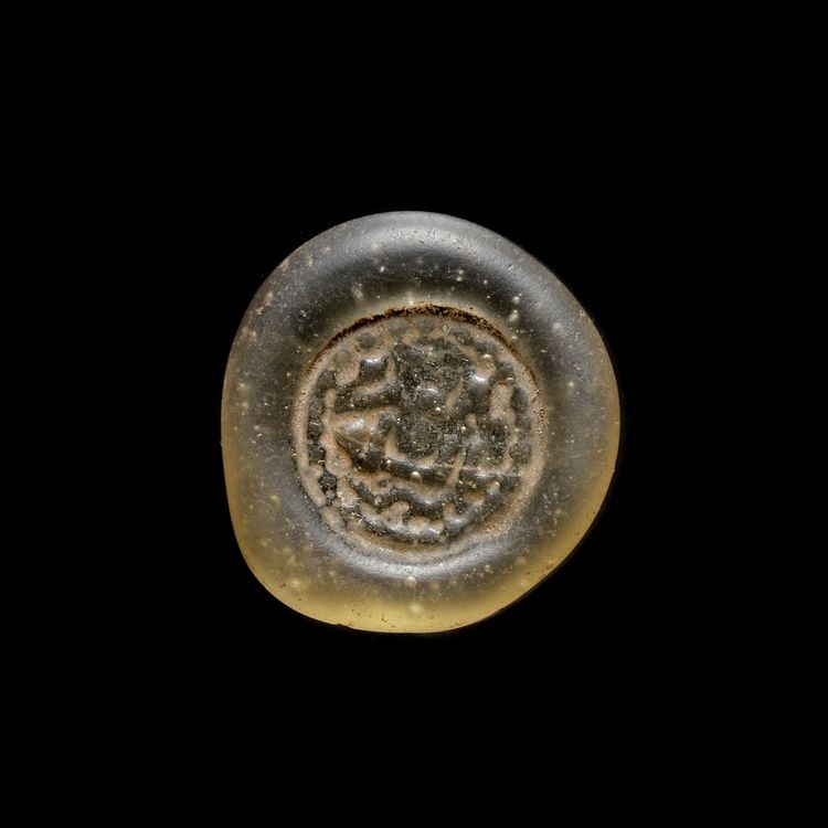 A FATIMID GLASS WEIGHT OF DOUBLE DIRHAM, EGYPT AL-AZIZ BILLAH ( 364-386AH/ 975-996 AD)