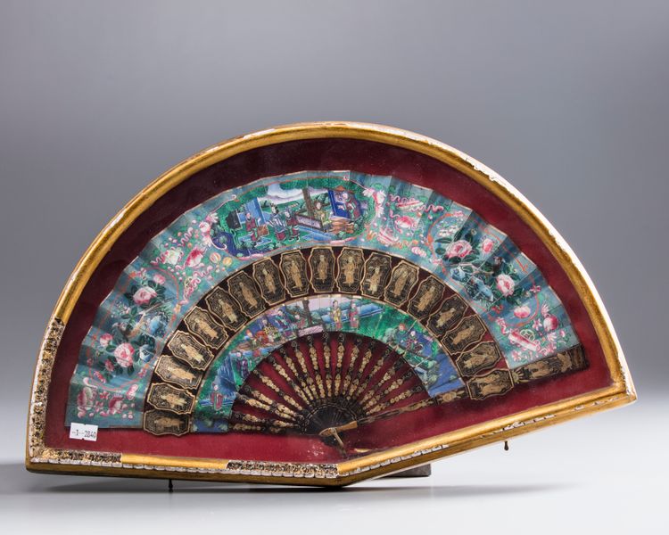 A Chinese Cantonese silk and paper fan with black lacquer guardsticks