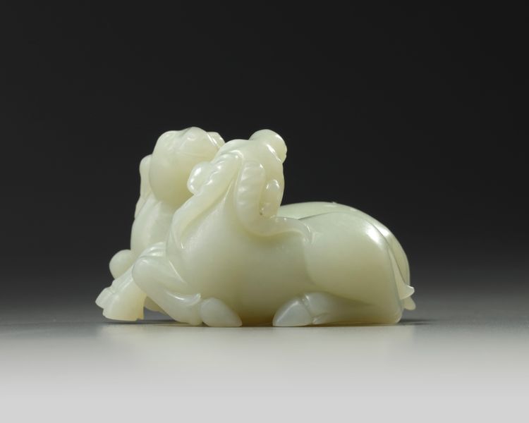 A Chinese pale celadon ‘twin ram’ carving