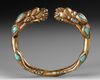 A SINO TIBETAN GILDED BANGLE, 19TH CENTURY