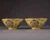 A pair of Chinese yellow-ground famille rose bowls