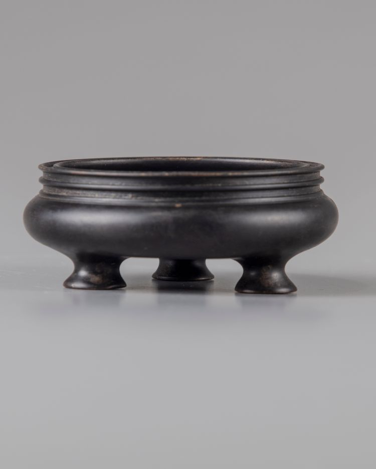 A Chinese bronze tripod censer