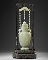 A Chinese pale celadon jade vase and cover