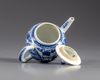 A blue and white teapot and cover
