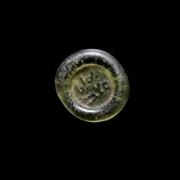 A FATIMID GLASS WEIGHT OF DIRHAM, AL-MUSTANSIR BI-ALLAH (AH 427-487 / 1036-1094 AD),