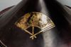 A conical black lacquered samurai hat (jingasa)