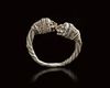 A ROMAN SILVER RING WITH LION-HEAD TERMINALS