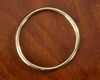 AN 18 CARAT YELLOW GOLD PLAIN HINGED SLAVE BANGLE
