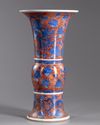 A Chinese iron-red-ground blue and white 'dragon and lotus' vase, gu