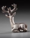 AN ELAMITE SILVER RECLINING STAG, CIRCA 2ND CENTURY B.C.