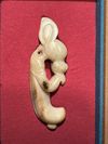 A CREAMY WHITE JADE CARVING OF AN EMBRYONIC MYTHICAL ANIMAL, CHINA, HONGSHAN CULTURE