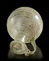 A ROMAN LIGHT GREEN GLASS JUG,1ST CENTURY A.D.