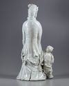An exceptional large dehua glazed figure of Guanyin with child