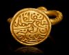 A GOLD INSCRIBED SEAL RING