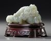 A CHINESE CELADON JADE CARVING OF A WATER BUFFALO GROUP, 19TH-20TH CENTURY