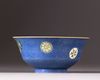 A Chinese blue-ground sgraffiato famille rose 'roundels' bowl