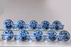 A group of eleven blue and white saucers and ten cups
