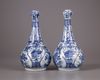 A pair of Chinese moulded blue and white 'Kraak' garlic neck vases
