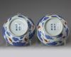 A pair of Chinese iron-red and gilt decorated blue and white bowls and cover