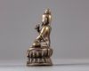 A bronze seated figure