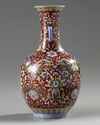 A Chinese red-ground famille rose bottle vase