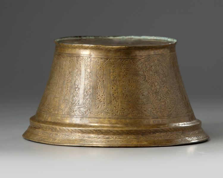 A brass Mamluk candle base
