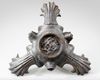 A ROMAN BRONZE THREE-NOZZLED OIL LAMP WITH THEATRE MASK AND ROSETTES AS DECORATION, CIRCA 1ST-2ND CENTURY A.D.