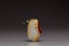 A white and russet jade 'melon' pendant