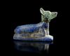 A LAPIS LAZULI RECUMBENT JACKAL, LATE PTOLEMAIC-ROMAN PERIOD, CIRCA 200 BC-100 AD