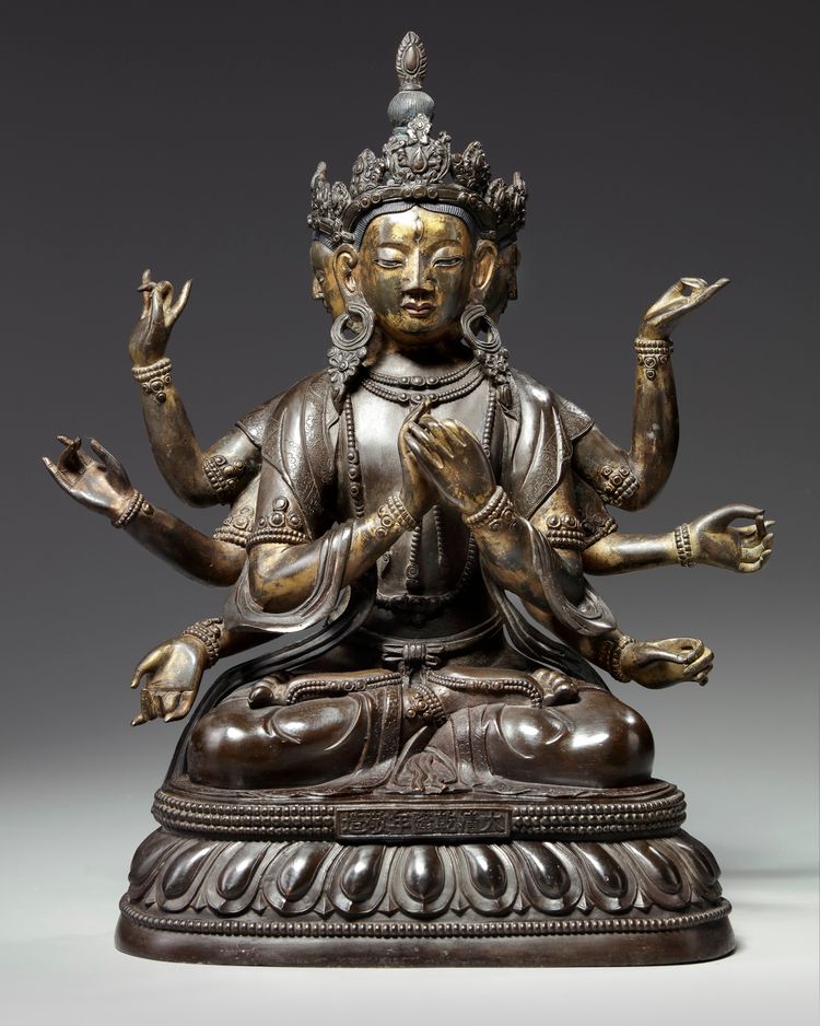 A Chinese cold-gilt bronze eight-armed Avalokitesvara