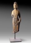 A FINELY CARVED STONE FIGURE OF A STANDING BUDDHIST DEITY