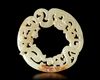 A WHITE JADE DRAGON/PHOENIX RING, HUAN, CHINA, HAN DYNASTY (206 BC-220 AD)