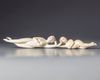 Two Chinese carved ivory reclining figures