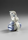 A BLUE AND WHITE BACCHUS ON A WINE BARREL, PROBABLY BRUSSELS 18TH CENTURY