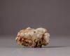 A Chinese pale celadon and russet jade 'boy and lingzhi' carving