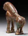 A BRONZE FATIMID MIRROR HANDLE IN THE FORM OF A LION, 11TH CENTURY
