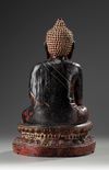 A Large Bronze Buddha Sitting on a Lotus