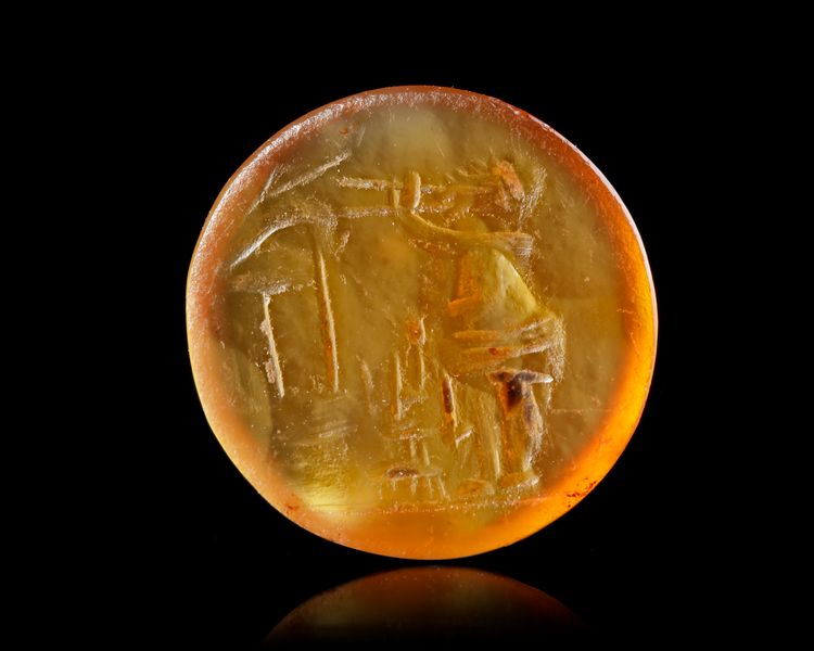 A ROMAN CARNELIAN INTAGLIO OF A SATYR, 1ST CENTURY AD