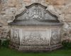 A CONTINENTAL SCULPTED LIMESTONE WALL FOUNTAIN, LATE 20TH CENTURY