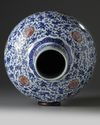 A Chinese blue and white and underglaze copper red-decorated ‘flower scroll’ bottle vase