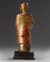 A Chinese gilt-lacquered bronze figure of a monk