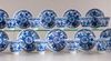 A group of eleven blue and white saucers and ten cups