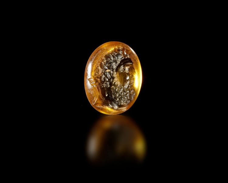 A ROMAN CITRINE INTAGLIO OF DIONYSUS, 1ST-2ND CENTURY AD