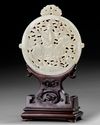A CHINESE WHITE JADE ARCHAISTIC OPENWORK PLAQUE ON A WOODEN STAND, 19TH-20TH CENTURY