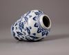 A Chinese blue and white jar with a copper oil lamp cover