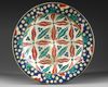 AN IZNIK-STYLE POLYCHROME POTTERY DISH, 19TH-20TH CENTURY