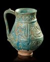 A TURQUOISE GLAZED POTTERY EWER, PROBABLY NISHAPUR, 12TH CENTURY