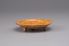 An earthenware marble-glazed dish on three small feet